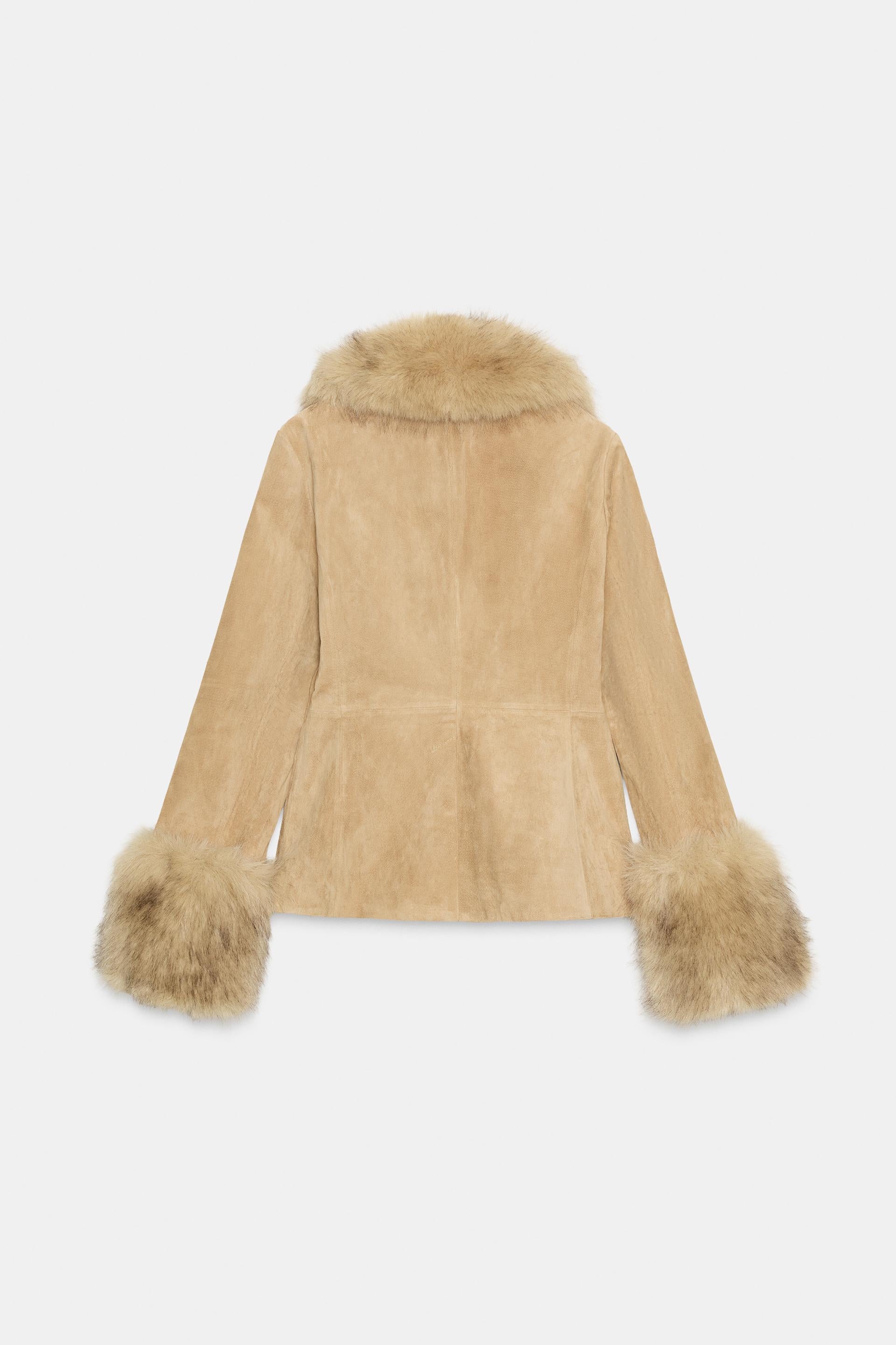 Beige faux fur jacket with cuffs on a light gray background